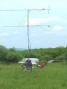 The K4KDJ "<i>intelligent antenna rotator</i>" -- Alex, KI4PCA, helps peak up the 144/432 mast on a station to the west, getting his cues from the operating tent, just out of frame to the left.