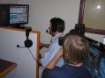 Arkansas section manager Dave Norris, K5UZ, operates from the Washington County EOC 1F station, W5FYV, for the cameras of one of the region's television stations, KFSM.