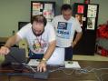 Shown are Roland-KC5UNL, Assistant OK Section EC, and John Thomason-WB5SYT OK Section Manager. Roland is demonstrating use of laptop computers in an emergency event including hosting a wireless network for Amateur Radio and served agency use.