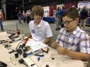 Nathan helps Matty with a soldering kit