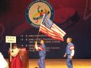 The parade of nations is an important part of opening ceremonies at ARDF World Championships. At the 2008 World Championships in Korea, Jay Thompson, W6JAY, carried the US flag across the stage after the ARRL placard, followed by Jay Hennigan WB6RDV, and the rest of ARDF Team USA. [Ken Harker, WM5R, Photo]