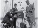 At Wiscasset, Maine, with the schooner Bowdoin, ARRL sponsors check out the receiver furnished by Zenith for the 1923 Arctic Expedition. (L-R) F.H. Schnell, 1MO, Traffic Manager; K.B. Warner, 9JT, Secretary-Manager; Hiram Percy Maxim, 1AW, ARRL President.