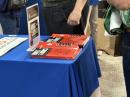 Attendees take turns thumbing through the 19th edition of Hints and Kinks, The POTA Book, and ARRL’s Tech-through-Amateur Extra license manuals. 
