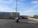 The W0EEE tower with the HF beam up, 40 meter dipole to the right and the 80 meter OCFD behind. [Sterling Coffey, N0SSC, photo]