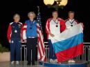 Ruth Bromer, WB4QZG, of Raleigh, North Carolina and Karla Leach, KC7BLA, of Bozeman, Montana (with the US flag) captured silver for Team USA by having the second-best combined score in the category for women over age 60 in the 80 meter competition. To their right are the gold medal winners from Russia. [Jay Hennigan, WB6RDV, Photo]