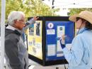 Mary Tanner (KI6GCX) at the information table showing folks what amateur radio is all about, explaining the role CARES plays for the city and the public display on Field Day.