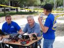 Cupertino Mayor Rod Sinks (center) who is also a fellow ham with call sign NW0R working an ICom IC-700 HF radio with Darryl Presley - KI6LDM (left) and Fari Aberg- KF6UVS (right) looking on.   (DSC_2173)