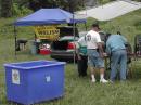Operating in a field behind the main building, members set up station equipment.  Not the containers they use to store their equipment for rapid deployment in the event of an emergency deployment.