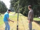 Hal, W7EC, and his assistant- Soren (a new ham without a callsign just yet) aims the Potato Howitzer to shoot a line over the 100 feet high fir trees.