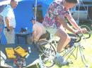 Rich, AE7RW, pedals the bicycle powered DC generator which powered the FT-817 QRP transceiver. The Voltage Regulator is in the inserted photo. 
Bill, W7IJ, is at the controls of the radio. 5 QSOs were made on 40 Meter CW. 
Interesting note: If the bicycle was pedaled too fast... components in the Voltage Regulator smoked. Also, when the rider quit pedalling... the radio died.