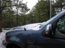 Pebble size hail occurred several times, covering the ground and my vehicle.