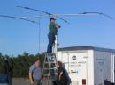 The 35' crank-up is being loaded with a tri-bander for 20 meters by K6SOE aided by N6PMF(L) and WA6CIE.