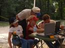 Kari assists Greg, K5DXA, while Kare rests. Ken, KD2KW, looks on.