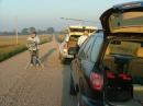 The NLRS Rover Pack parked on rural road in SW Minnesota. To the left in the photo is W9FZ looking for contacts to the East.  To the right (his back to the camera) is WB0LJC.  Closest to the camera is the open rear compartment of the W0JT rovermobile.