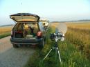 The W0JT rovermobile with my 10 GHz tripod-mounted rig in the grass on the roadside.  Thank goodness that SOME Minnesota farmers grow beans instead of corn!