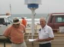 Dave Glawson, WA6CGR (left) explains how the wind generator works to VIP visitor Gordon West, WB6NOA,