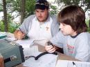 Joseph Hood (12 years old), right, is introduced to Field Day by Jason Campbell (KG4WGB), member of the Radio Amateur Club of Knoxville in TN.
