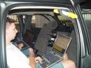 The second operating station.  Yes, the back of a comfortable pickup truck.  Note digital operations are ongoing on one laptop with logging on the other through the TS2K/Tuner in the middle.