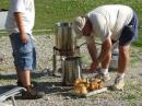 Tim, K8TAT and son Nate getting the chicken ready for a hungry mob!
