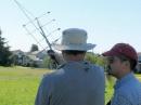 VE7CNV and VA7IMR attempting a satellite QSO with a multiple coat hanger element, dual band YAGI antenna. The duct tape is hanging.  The elements seem to be slightly bent.   