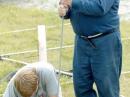 Glen Felt's nephew Brandon Kagy (left) and Bob Musil (KA0BTY) cut lengths of threaded steel to use for tower anchors on Field Day.