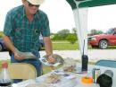 A visitor to the Field Day site at Willard L. Meyer NRD Area northeast of Tobias picks up some pamphlets on amateur radio from the information table.