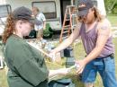 Nancy Templeton (KC0UPE) and her husband, Andrew (KC0UPF) sort the pieces of the tent framework before assembly.