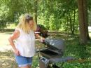 Teresa gets the grill ready for burgers and dogs.