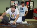 Shown are Roland-KC5UNL, Assistant OK Section EC, and John Thomason-WB5SYT OK Section Manager. Roland is demonstrating use of laptop computers in an emergency event including hosting a wireless network for Amateur Radio and served agency use.