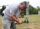 Rick Hannan, N9XGM, hammers in a stake as he and  Jordan Carter, K9NZF, work to secure a temporary tower as the emergency communications group EmComm ECI sets up the W9YFD Field Day site in Muncie, IN on Saturday, June 23, 2007.