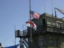 Raising the 80 meter dipole, along with the American and Royal Navy flags. This building is used for emergency services repeaters.