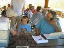 Young prospective ham, Harrison Sanders making his very first ham radio contact while his dad, Mark Sanders (L) and Jack Ciaccia, WMØG (R) looks on.