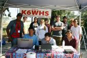 Wilson AREC team standing at their ten with a computer set up and a K6WHS banner in the background sunday morning after Field Day.jpg