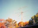 Dual-polarization 4-yagi array at K1JT, with beautiful fall colors in the background. Single yagis for 50, 222, and 432 MHz are atop the EME array.