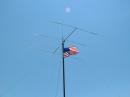 Close of shot of "Old Glory" flying atop mast #1.